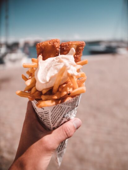 close up photography of french fries with cream