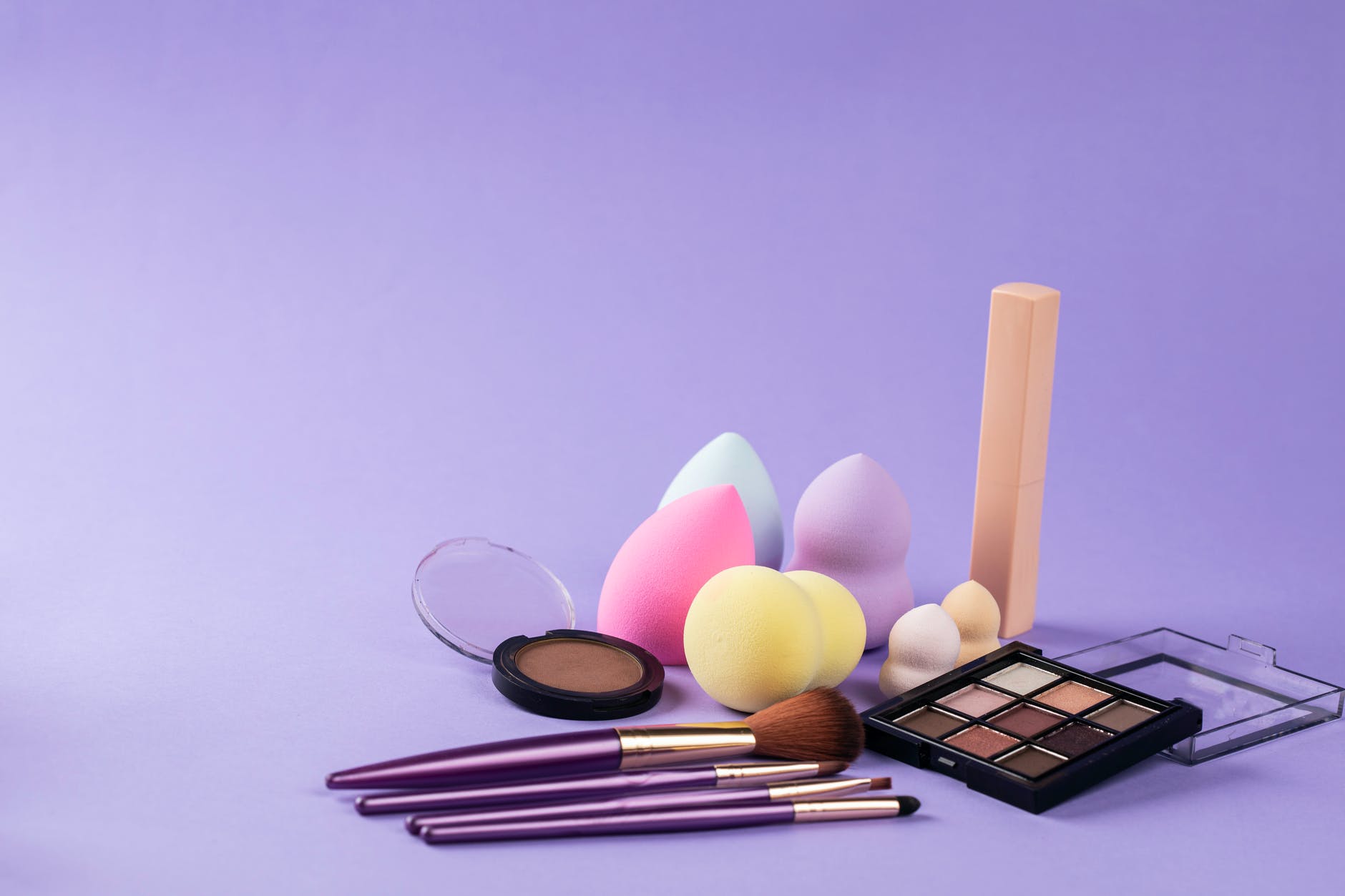 makeup tools on purple surface