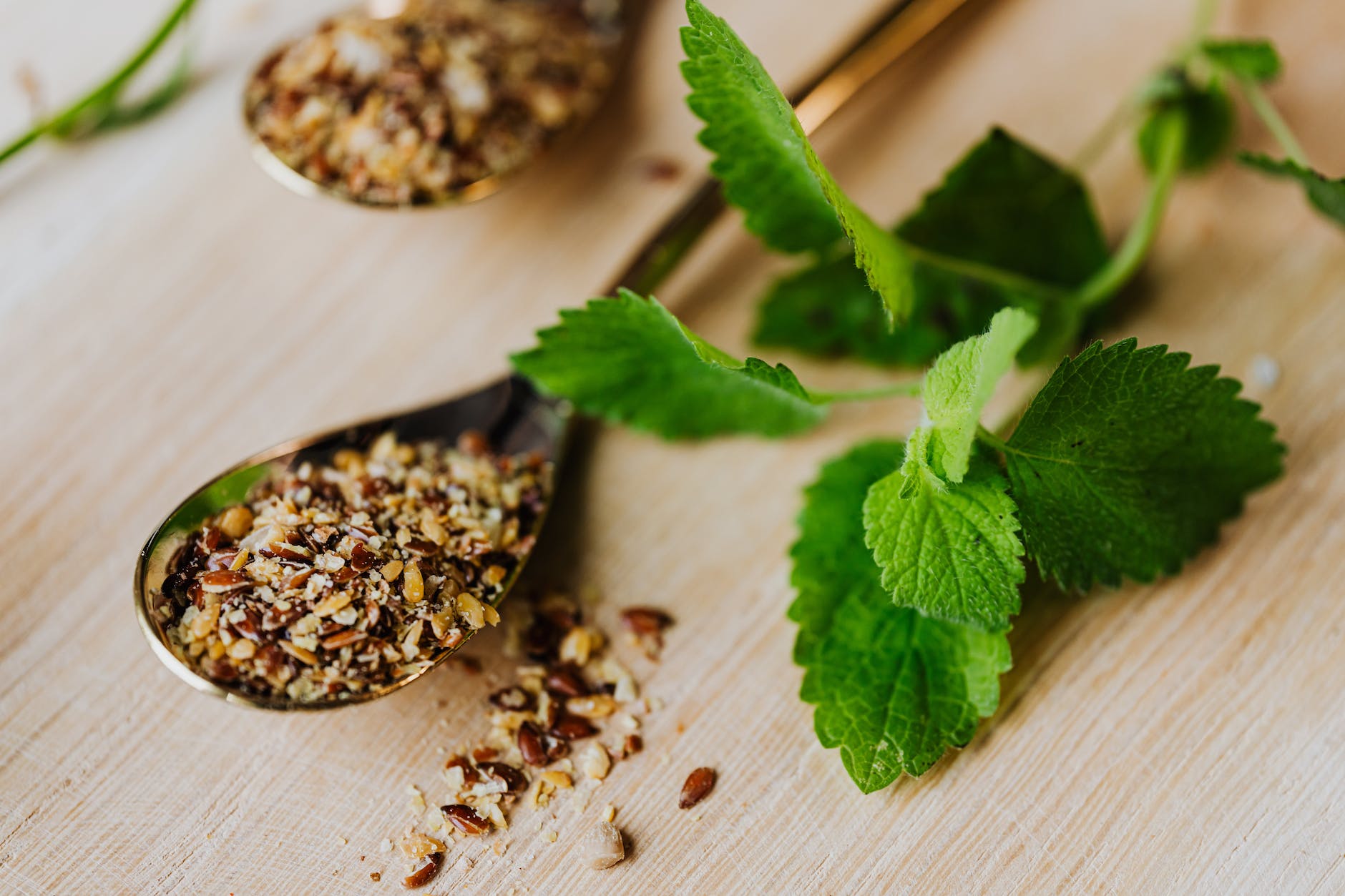 mint leaves and spices on teaspoon