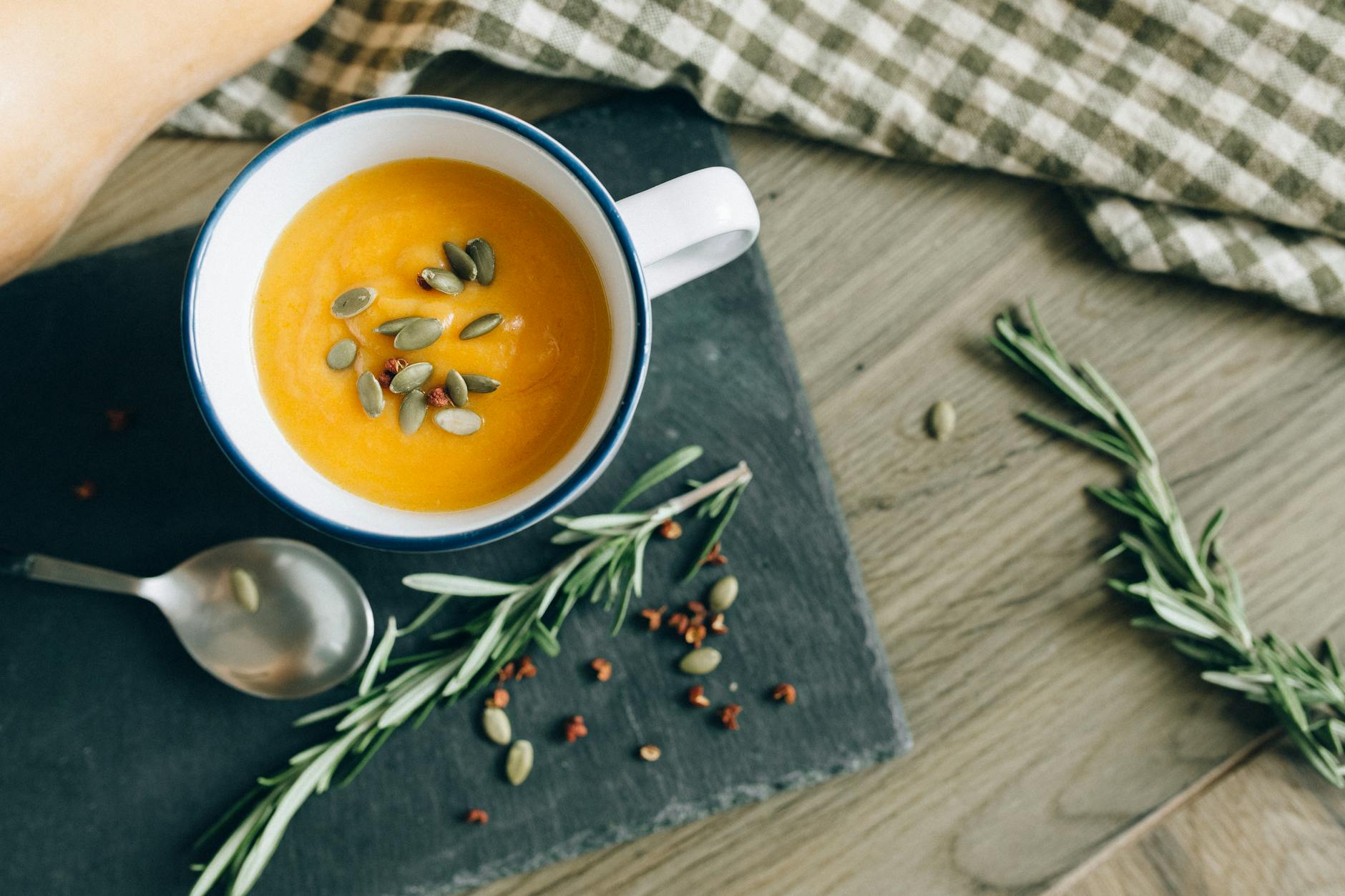 overhead shot of pumpkin soup in a mug